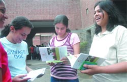 Students check admission forms at St. Stephens College in Delhi University in New Delhi