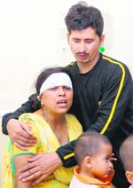 An injured Archana mourns the death of her relatives in an accident near Shamgarh in Karnal on Monday. 