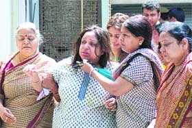 Relatives console daughter of Ashok Goel and Lata Goel, who were found murdered at their residence in Niti Bagh in New Delhi