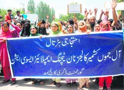 Members of the non-gazetted college employees association protesting against the state government to fulfil their pending demands in Srinagar on Monday.