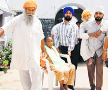 Parkash Kaur (90) and Surjit Singh (75) being carried by their relatives to a polling booth at Attari on Monday.