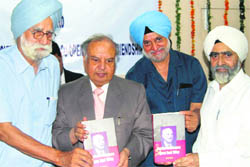 Chief Justice of Punjab and Haryana High Court Vijender Jain releases a book authored by Dr Prem Singh in Chandigarh.