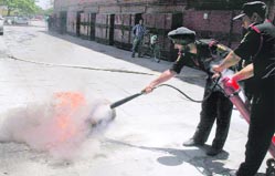 Employees of a multiplex demonstrate their fire-fighting technique to MC officials at