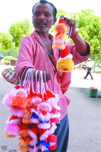 A man sells dolls at India Gate