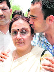 Neelam Katara, mother of Nitish Katara is seen with her son Nitin at Patiala House Court in New Delhi on Wednesday.