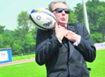 IOC chairman Jacques Rogge tries to catch a rugby ball during a visit at the newly inaugurated gymnastics, handball and tennis halls of the Romanian Olympic Preparation Centre near Bucharest on Wednesday.