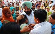 MLA Gurpreet Singh Kangar consoles the family members of Sham Lal at the cremation ground in Bhagta Bhai village.