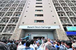 Anxious Pakistani stockbrokers gather outside the Karachi Stock Exchange to express their worries over the continued slump in the share market in Karachi on Thursday. The benchmark KSE 100 index fell by 10 per cent in a week after the central bank raised interest rates by 1.5 per cent to fight against the rising inflation in the country.