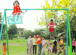 Children get out of their homes to enjoy the summer breeze at Chandigarh on Thursday.