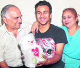 Rahul Vij celebrates his success with his parents in Mohali on Thursday.