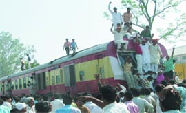 A train is stopped at Noli railway station near Loni in Ghaziabad