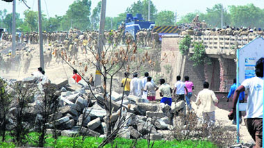 Villagers charge at policemen after two protesters died allegedly in police firing in Pattikalyana village, near Panipat, on Thursday.