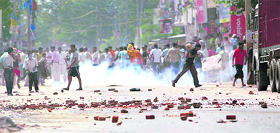 Gujjar protesters brave tear gas while throwing stones at security personnel during their demonstration at Aya Nagar in New Delhi on Thursday.