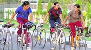 Cyclists return after a practice session at PAU in Ludhiana on Thursday.