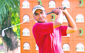 Mhow golf veteran Mukesh Kumar plays a shot on the third day of the PGTI Players Championship at the Chandigarh Golf Club on Friday. Mukesh leads the field by just one stroke.