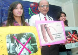 Dr K.K Aggarwal, president, Heart Care Foundation, poses with models at a press conference on ''Ban Tobacco Advertising'' on the eve of World No Tobacco Day in New Delhi.