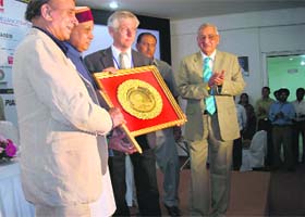 Chief Minister Prem Kumar Dhumal receives the Golden Peacock Award at Palampur