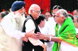BJP leader B.S. Yeddyurappa being greeted by Punjab Chief Minister Parkash Singh Badal after taking oath as the new Karnataka Chief Minister, during the swearing-in ceremony in Bangalore