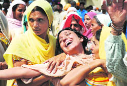 Jamna Rani, sister (centre) of slain Congress worker Veerpal Veeru, wails at Rampura Phul Civil Hospital on Friday.