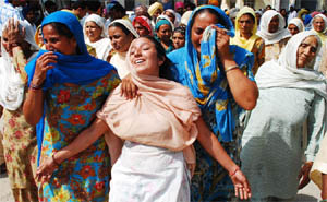 Jamna Rani, sister (centre) of slain Congress worker Veerpal Veeru, grieves at Rampura Phul Civil Hospital on Friday.