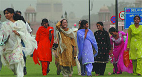 Girls enjoy the weather at Rajpath in New Delhi on Saturday. 