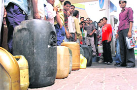 Consumers queue up at a petrol station to buy diesel in drums in Ludhiana on Saturday.