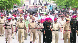 A heavy posse of police scans the disrupted area in Ludhiana.