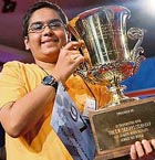 Sameer Mishra (13) holds the 2008 Scripps National Spelling Bee Trophy after winning the annual tournament in Washington on Friday.