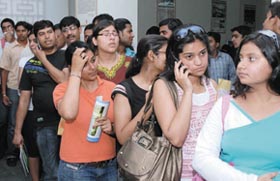 Students outside Hindu College to buy admission forms; and students queue up to get admission forms at Kirorimal College on Monday.