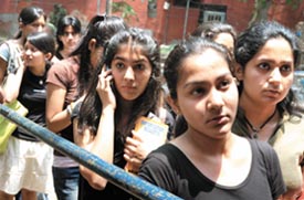 Students outside Hindu College to buy admission forms; and students queue up to get admission forms at Kirorimal College on Monday.