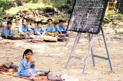 Despite clear instructions not to bring schoolchildren to official functions, these students await the arrival of the Chief Minister recently outside a convention centre in Palampur.