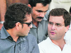 Rahul Gandhi talks to Sachin Tendulkar as they watch the Rajiv Gandhi Rural Cricket Tournament in Amethi on Monday.