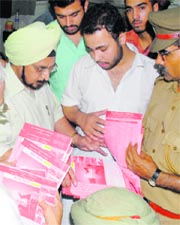 Officials inside the SBI cash counter check the serial numbers of the prospectuses