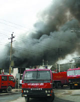 Smoke billows out of an electric meter factory in Sector- 58 in Noida, which caught fire on Tuesday.