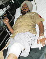 The security guard of the van who suffered a bullet injury, under treatment at a hospital in Amritsar.