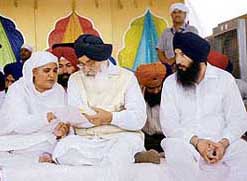 Chief Minister Parkash Singh Badal and former SGPC chief Bibi Jagir Kaur discuss a point during a function to mark the the 58th death anniversary of Sant Prem Singh Murarewale at Begowal village in Kapurthala on Tuesday.