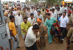 The rescue team pulls out one of the two labourers who were buried in the well after the earth caved in at Kothe Phula Singh Wale village in Bathinda on Wednesday.