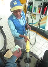A motorcyclist purchases petrol at a petrol pump in New Delhi. nesday. 
