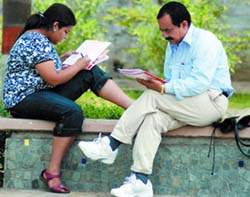 A student fills in her admission form with the help of her father at Delhi University on Wednesday. 