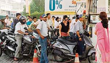 Customers queue up at a petrol station in Ludhiana on Wednesday
