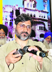 Prof S.A.R Geelani relays speech of chairman of the breakaway faction of the Hurriyat Conference Syed Ali Shah Geelani through his cellphone at a conclave organised by the Dal Khalsa in Amritsar on Wednesday.