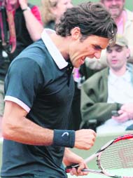Swiss Roger Federer reacts after beating Chilean player Fernando Gonzalez in the quarterfinal of the French Open, at Roland Garros, in Paris, on Tuesday. Federer won 2-6, 6-2, 6-3, 6-4.