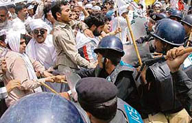 The Pakistani police scuffle with government employees during a protest rally in Lahore on Thursday to denounce soaring price hikes in the country.