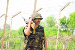 A BSF jawan patrols the international border in Samba