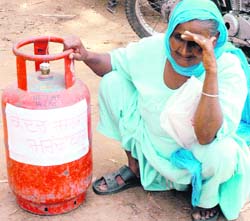 An old woman in protest against hike in the price of cooking gas in Patiala on Thursday. 