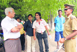 Prof Naval Kishore, DSW, talks to crew members of the serial after the accident near Gandhi Bhawan at PU on Friday. 