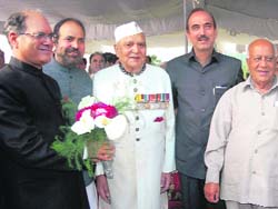 Newly-inducted minister B.R. Kundal (L) poses for a photograph with Deputy CM Muzaffar Hussain Baig, Governor Lt-Gen S.K. Sinha (retd) and Chief Minister Ghulam Nabi Azad in Srinagar on Friday. 