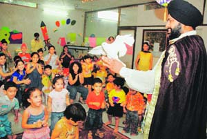 A magician enchants tiny tots of Maple Bear in Ludhiana on Friday. 