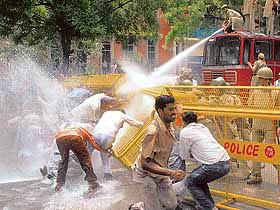 Delhi police officials use a water cannon to disperse activists of the BJP during a protest against the UPA governments hike in petroleum products in New Delhi on Friday.