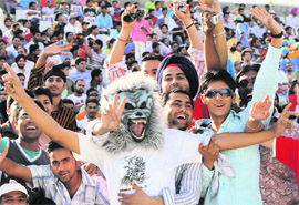 Those caught on camera wildly wave their hands and laugh with joy when they see themselves on the large screens at different corners of the cricket field.